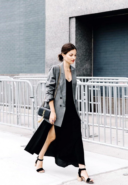 Модный лук: легкое черное платье-комбинация, серый удлиненный пиджак в клетку, черные босоножки с ремешками и миниатюрная черная кожаная сумочка на цепочке